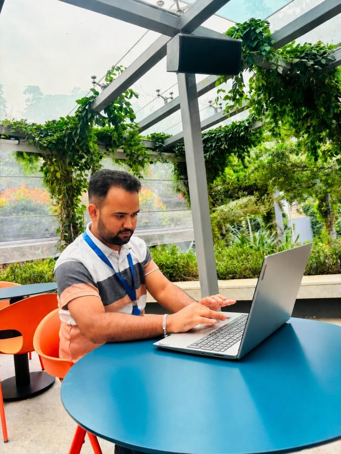 Biju working on his laptop